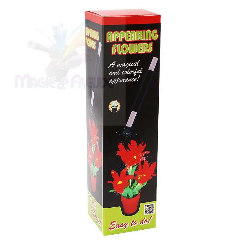 Eine rechteckige Schachtel für den Zaubertrick ’Appearing Flowers’ mit einem Zauberstab und einer Topfpflanze mit roten Blüten.