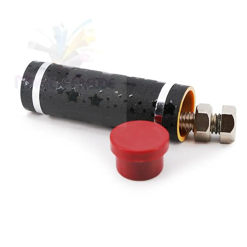 Ein schwarzes, sternförmiges, zylindrisches Rohr mit silbernen Bändern, das an einem Ende offen ist und einen orangefarbenen Innenraum sowie einen Gewindebolzen mit zwei Muttern neben einer roten Kappe zeigt.