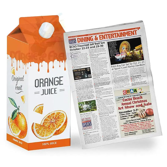 Eine Packung Orangensaft neben einer Zeitung.