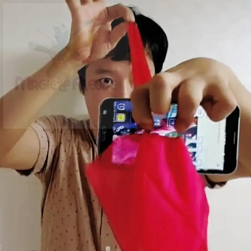 Eine Person hält ein Smartphone und ein rotes Tuch.