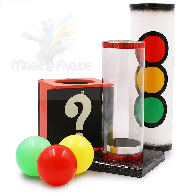 Ein Zaubertrickset mit einer Fragezeichenbox, einer klaren Röhre, einer Ampelröhre und drei farbigen Kugeln.