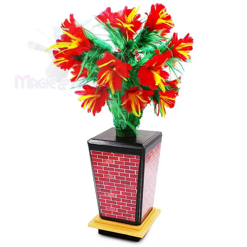 Künstliche rote und gelbe Federblumen in einem Topf mit Ziegelmustern.