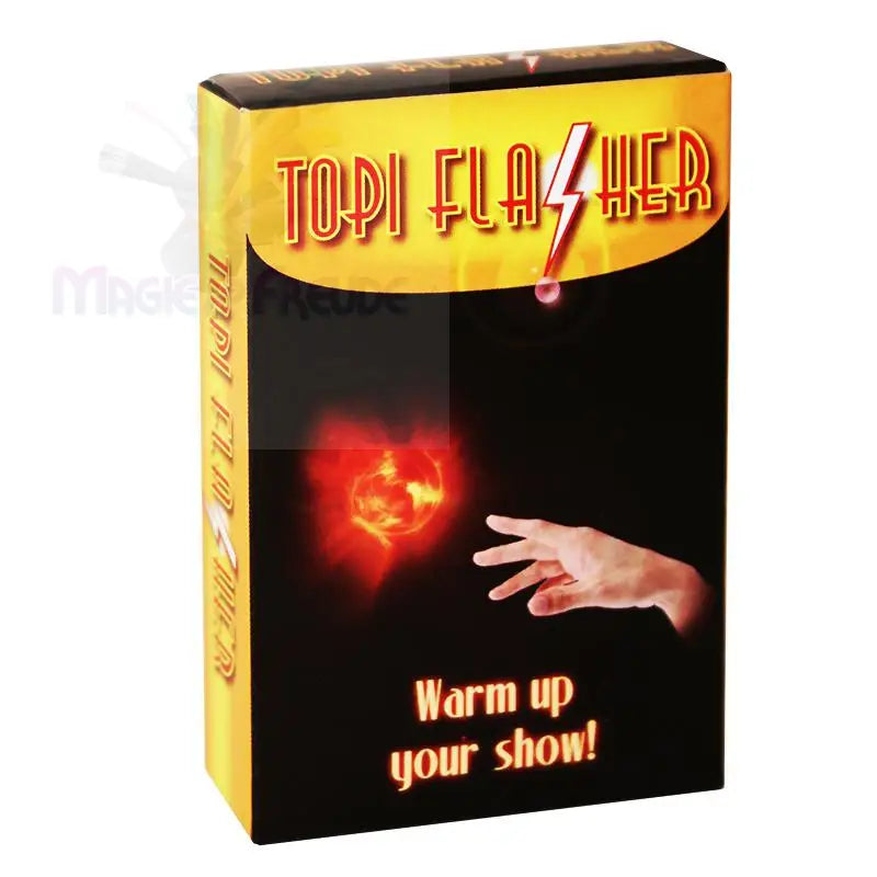 Ein schwarzer Kasten mit gelbem Deckel wirbt für einen Zaubertrick mit einer leuchtenden roten Kugel und einer Hand, mit dem Text ’Warm up your show!’.